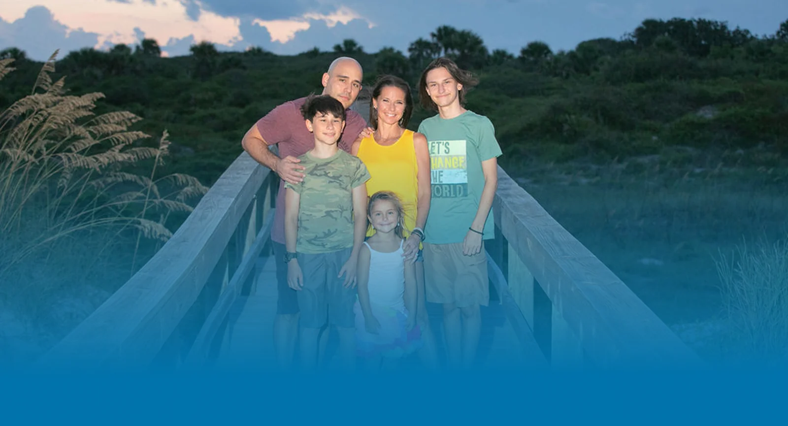 Dr. Sebastian T. Castelli with his family on a coastal boardwalk